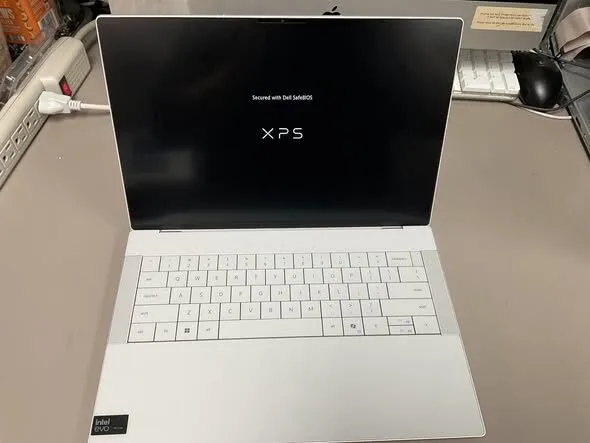 White Dell XPS laptop being tested after repair